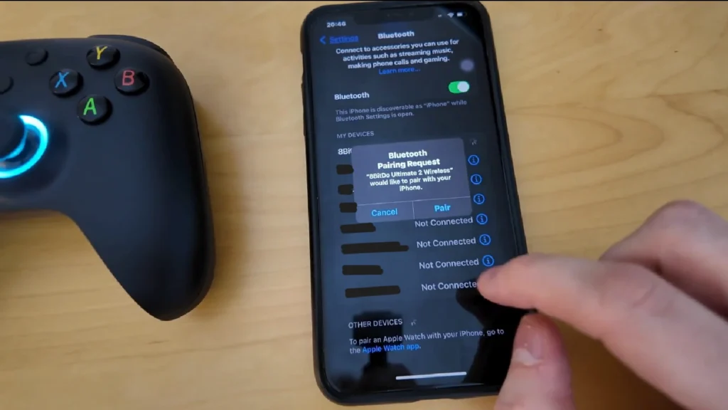 8BitDo Bluetooth controller paired with mobile phone running a retro JRPG via emulator in the Philippines